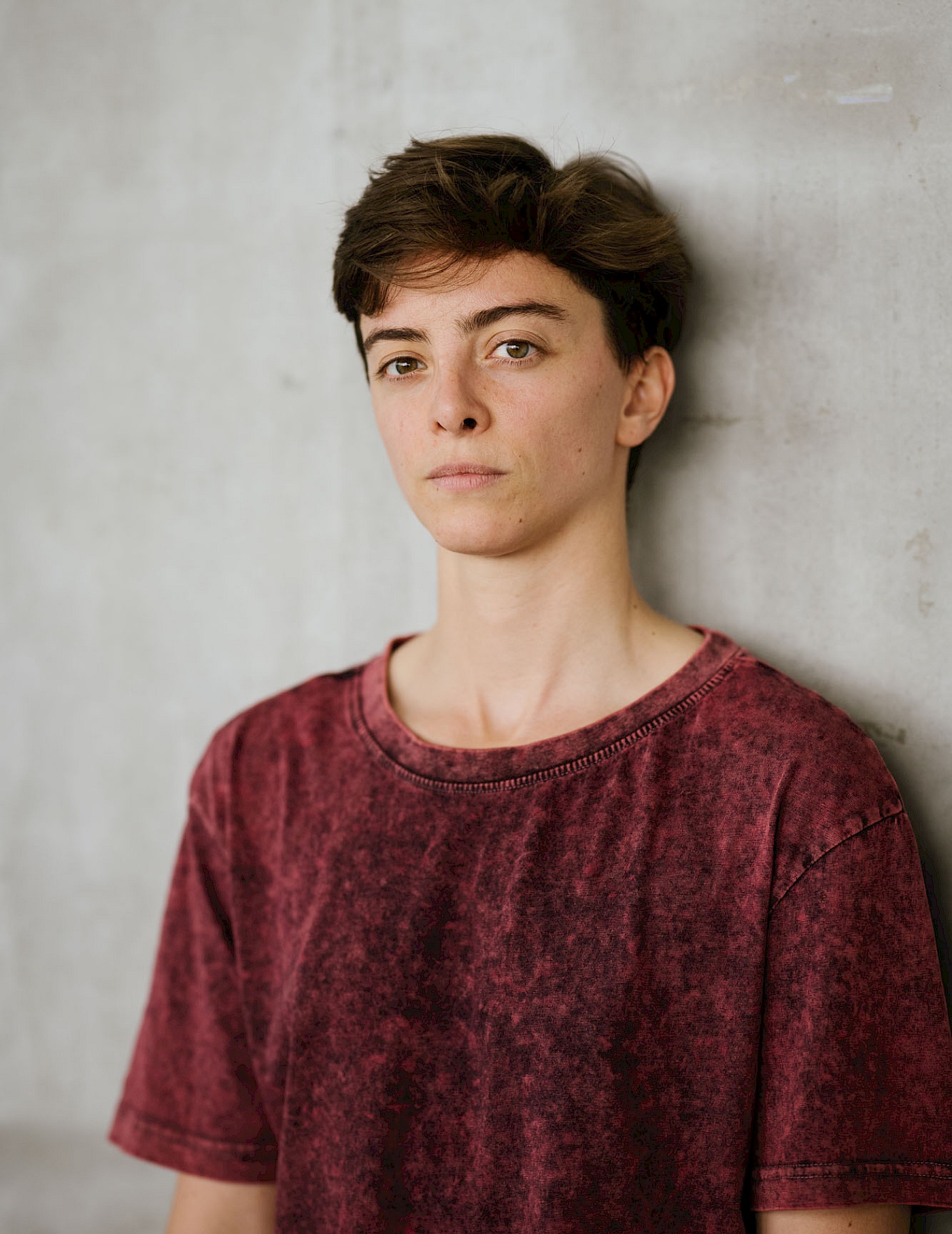 Phil Dera Portrait of Julia B. Laperrière with short dark hair and a red T-shirt.